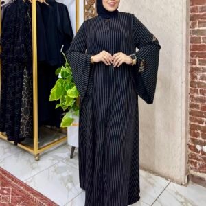 كلوش 1 Woman in stylish black striped dress.